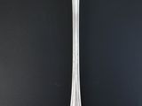 silver spoon on a black surface with a black background