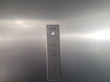 a close up of a stainless steel refrigerator with the door open