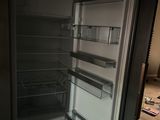 an open refrigerator that is sitting in a room
