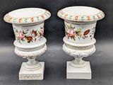 two vases that have been painted with flowers on them
