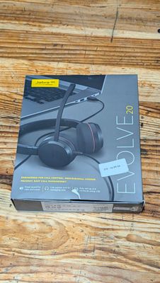 the box of a pair of headphones sitting on top of a wooden table
