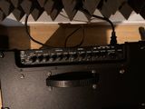 a guitar amp sitting on top of a wooden table