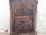 a small wooden cabinet with a bowl on top of it