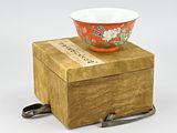 a small bowl sitting on top of a wooden box