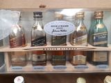 many bottles of liquor in a box on the table