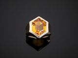 a ring with an orange topaz stone in the middle of it
