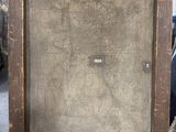 an old painting is sitting on a wooden easel in a room