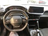 the interior of a car with a steering wheel and dashboard controls