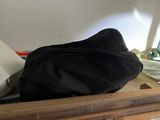 a black bag sitting on top of a wooden dresser