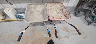 two wheelbarrows that are sitting in the garage