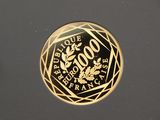 an image of a gold plated coin on a black surface