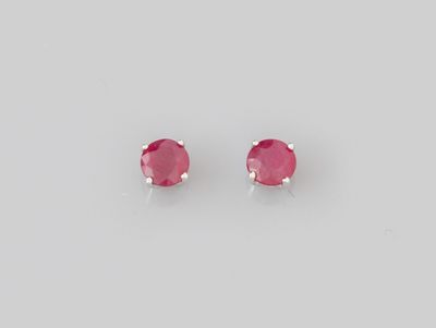 une paire de boucles d'oreilles à clous en saphir rose sur fond blanc