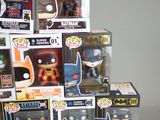 a lot of batman pop vinyl figures on the table