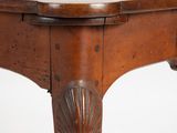 a wooden table with carvings on the top of it