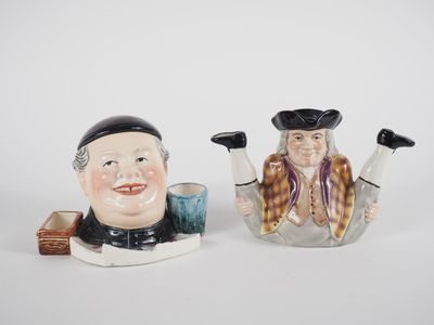 pair of ceramic figurines of two men with hats and tails