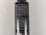 a close up of a bottle of sham on a white surface
