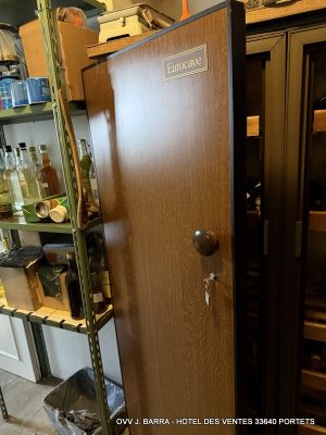 a wine cooler in the corner of a room with shelves