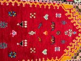 rug on the floor with a red background and a yellow border