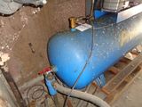 a blue tank sitting in a room next to a wall