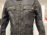 leather motorcycle jacket on display in a store with a price tag