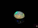 an image of a white oplite in the dark