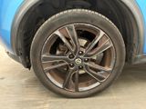 a close up of a tire on a blue car