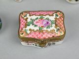 a small box with a flower on it next to other small boxes