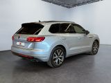 the rear end of a silver volkswagen suv parked in a garage