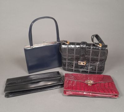 three purses and a wallet sitting on a table
