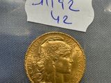 a close up of a gold coin with a price tag on it