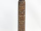 a brown vase that is sitting on a white surface