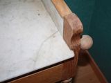 a marble counter top with a wooden handle on it