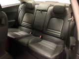 the back seats of a car are black with red trims