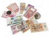 a lot of different foreign currency on the table