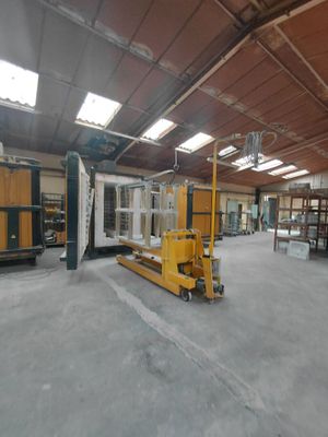 a large warehouse with a fork lift in the middle of it