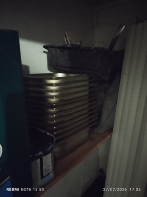 a stack of pots and pans on a shelf in a kitchen