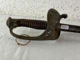 a very old sword that is laying on a table