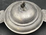 a silver plate with an apple on it on a table