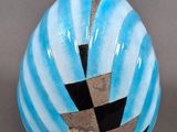 a blue vase with a black and white design on it
