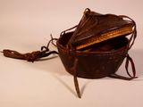 a small brown bag with a handle on a white surface