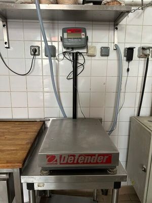 a scale on a table in a kitchen with a lot of counter space