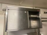 a metal cabinet in the middle of a kitchen