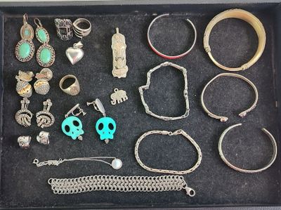 a black tray with a variety of rings and bracelets