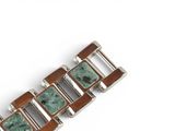 an image of a close up of a bracelet on a white surface