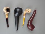three different types of smoking pipes are lined up on a table