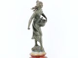 an image of a statue of a woman holding a basket