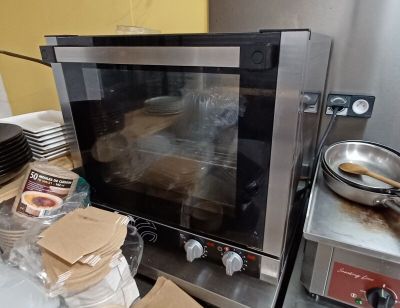 a microwave that is sitting on a counter with a lot of food inside of it