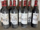 six bottles of wine are lined up in a row on a table