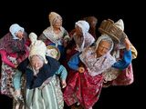 many figurines of people dressed in traditional clothing