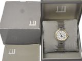 a box with a watch inside of it on a white surface